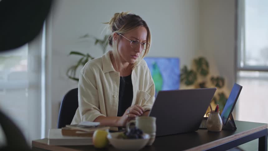 A woman sits at her desk