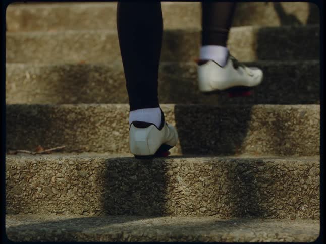 A close up of concrete steps as a person walks up them
