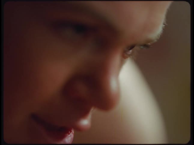 An up close of a womans face as she is sweating flush and looking aggressively