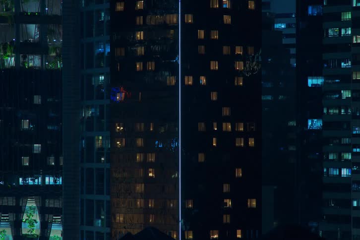 The lights flash and flicker in the buildings