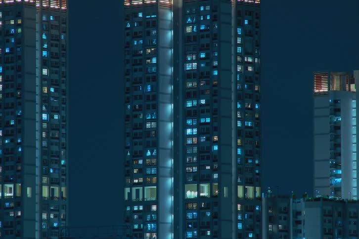 City lights twinkling from inside skyscrapers at night