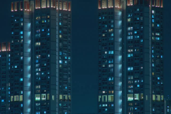 Lights flickering from skyscraper windows in a city at night