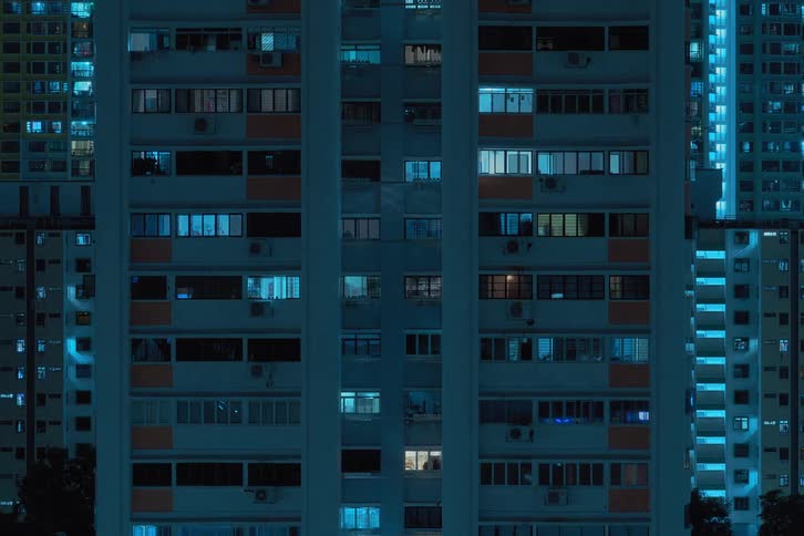 Time lapse of apartment buildings with flickering lights from the windows