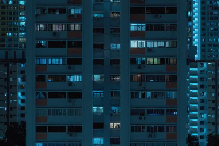 Blue and white lights flash inside futuristic towers and buildings in a modern city