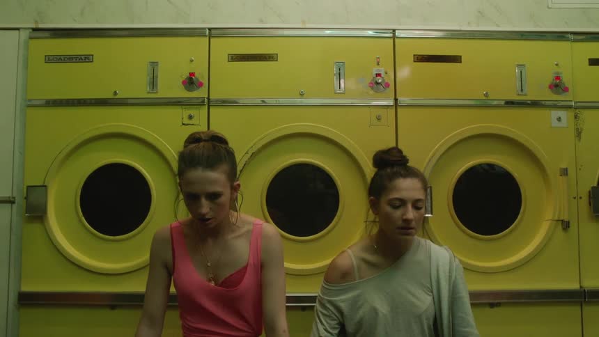 Two women are waiting for their laundry to be done