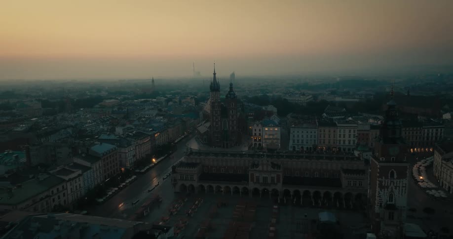 Heavy fog settles over a city with historical buildings