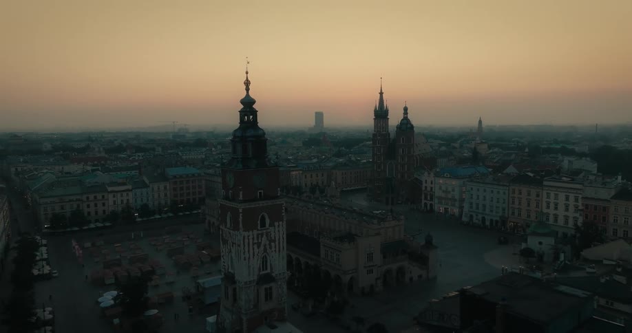 An aerial view of a city with tall clock tower buildings
