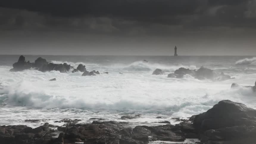 Waves crash against rocks on the shore