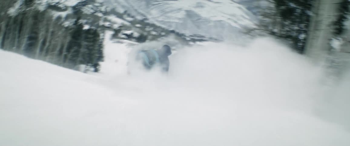 There are people that are snowboarding outdoors in the winter time