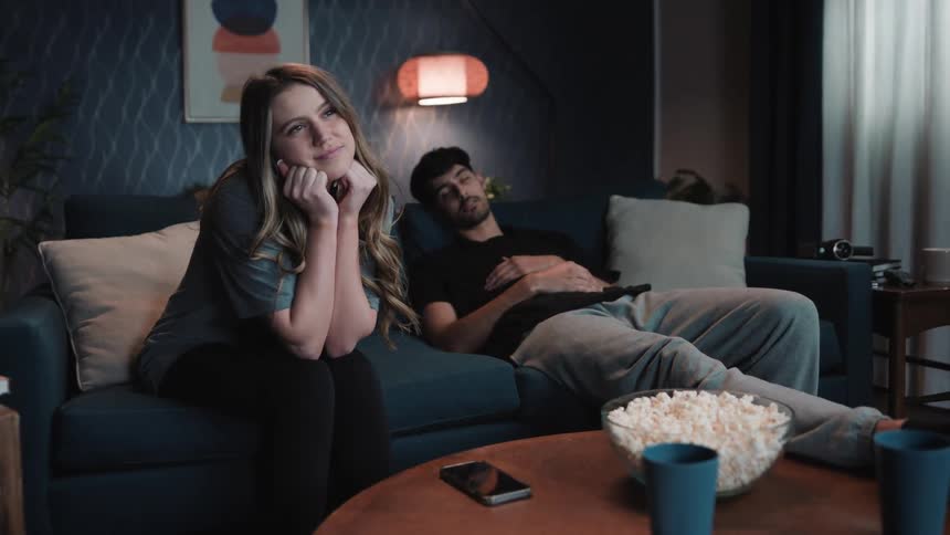 A man and woman watch something together