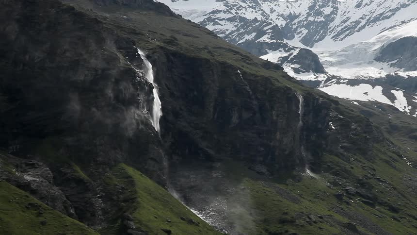 Water falls off the side of a mountain