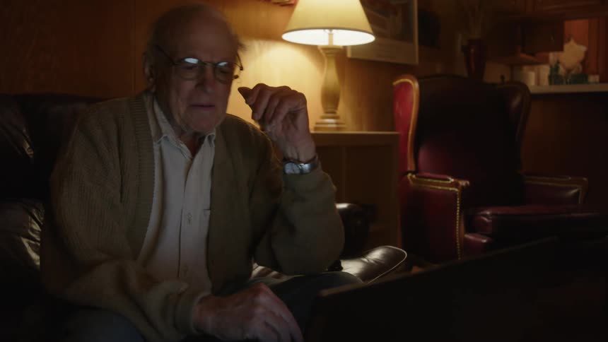 A man is looking at his laptop