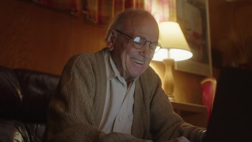 A man sitting around using a laptop