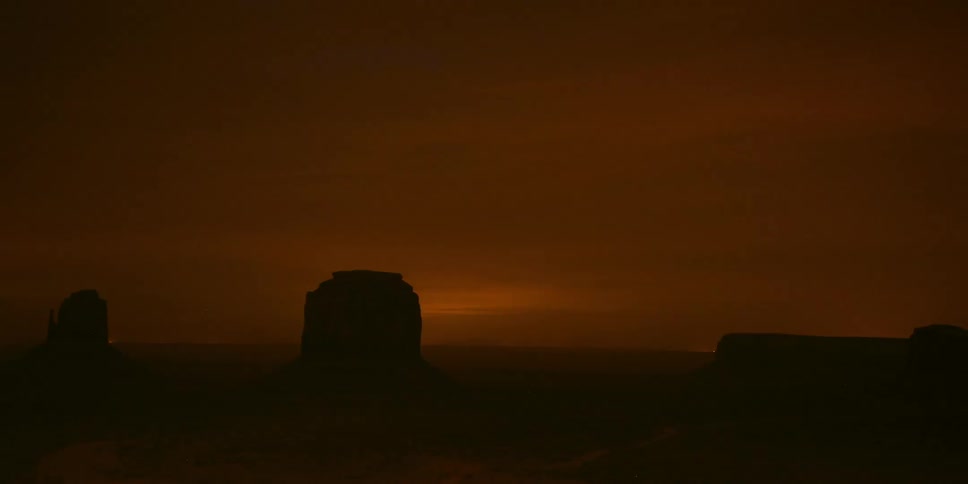 Clouds moving past a rock formation