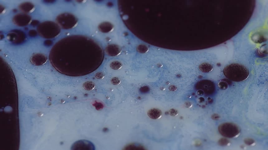 A close up of a soapy oily liquid that has bubbles in it