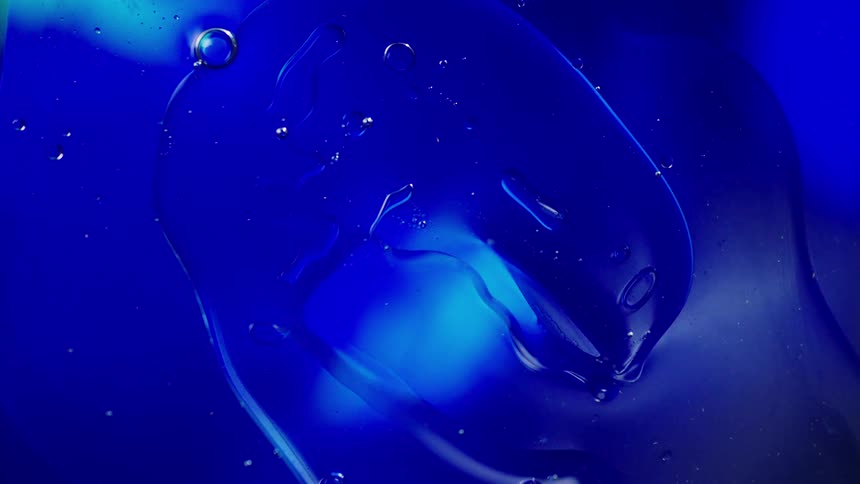 Clear blue paint moving and creating bubbles