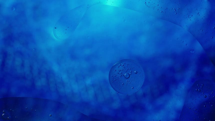 Light shines on electric blue water as it ripples and moves