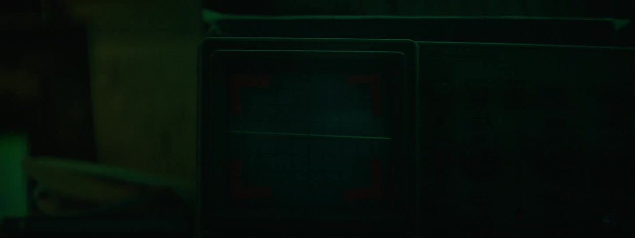 A black screen with a green lase beam running across it