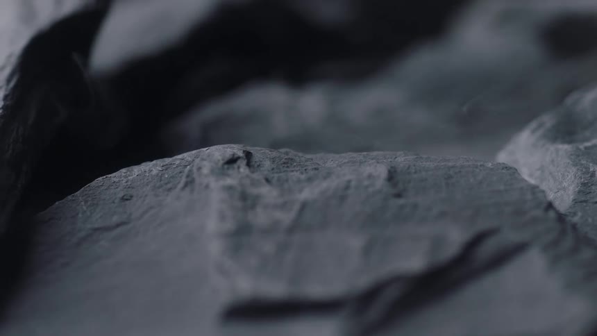 Close up view of mist covered rocks are displayed