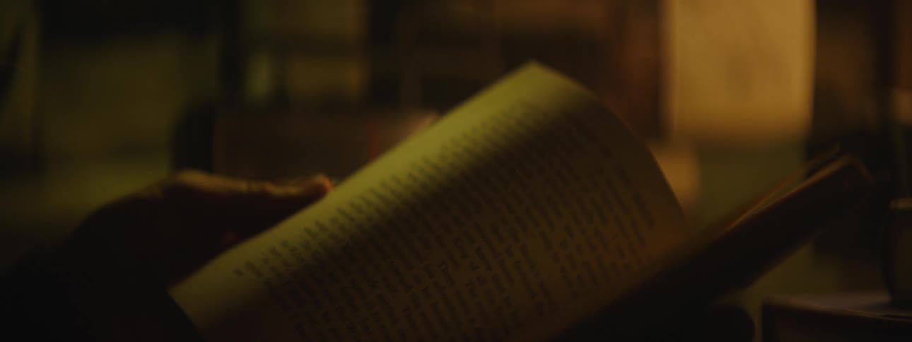 An up close of a person turning the pages of a book