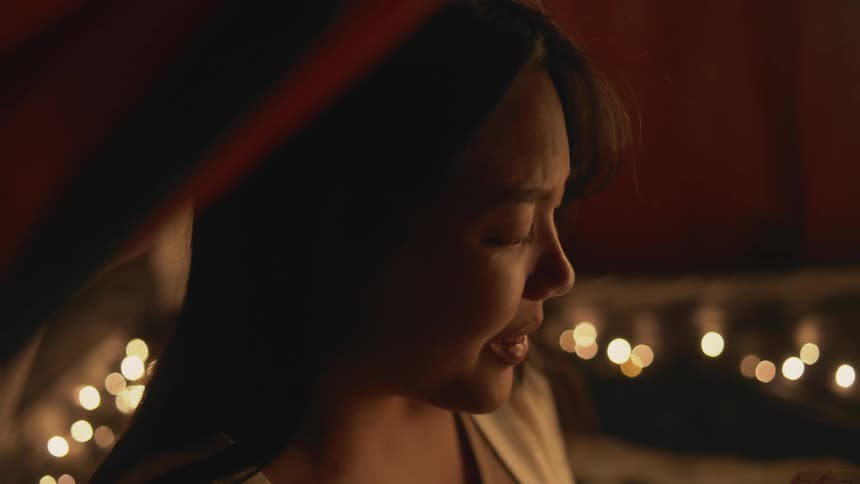A close up of a womans face talking and then smiling