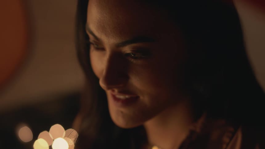 An up close of a womans face smiling as she blinks
