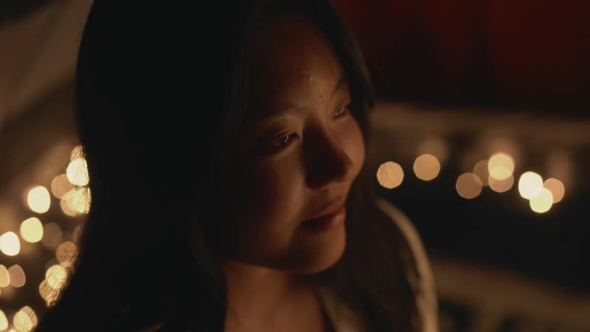 The view is of a young woman and she is smiling