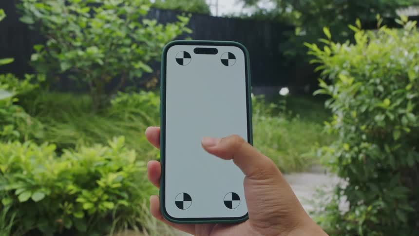 A teenage girl is standing outside holding a cell phone as she moves her thumb across the gray screen