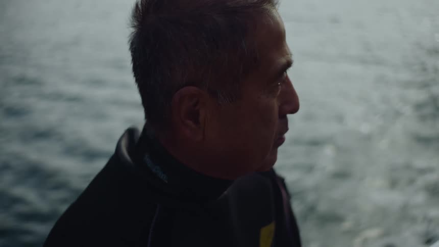 The view is of an older man that is by the ocean