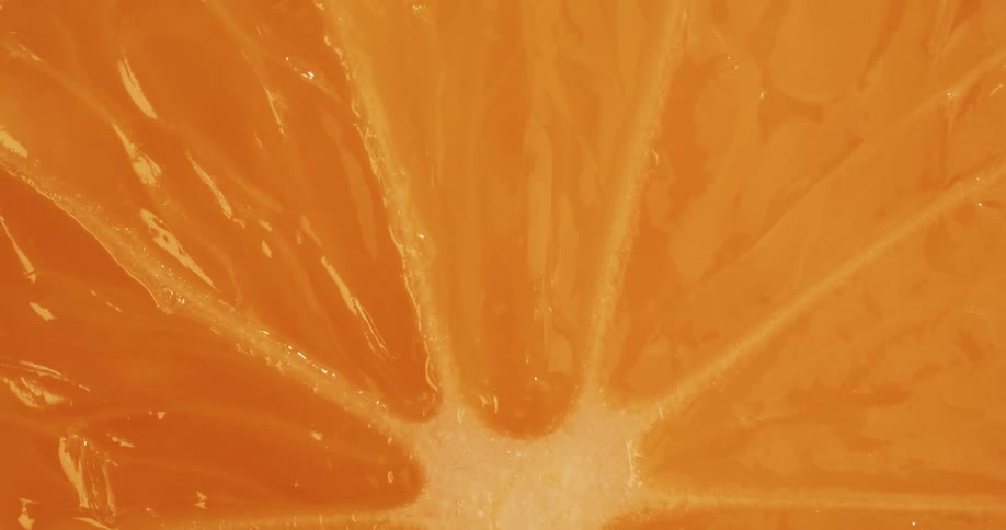 An extreme up close of the inside of an orange as it spins around