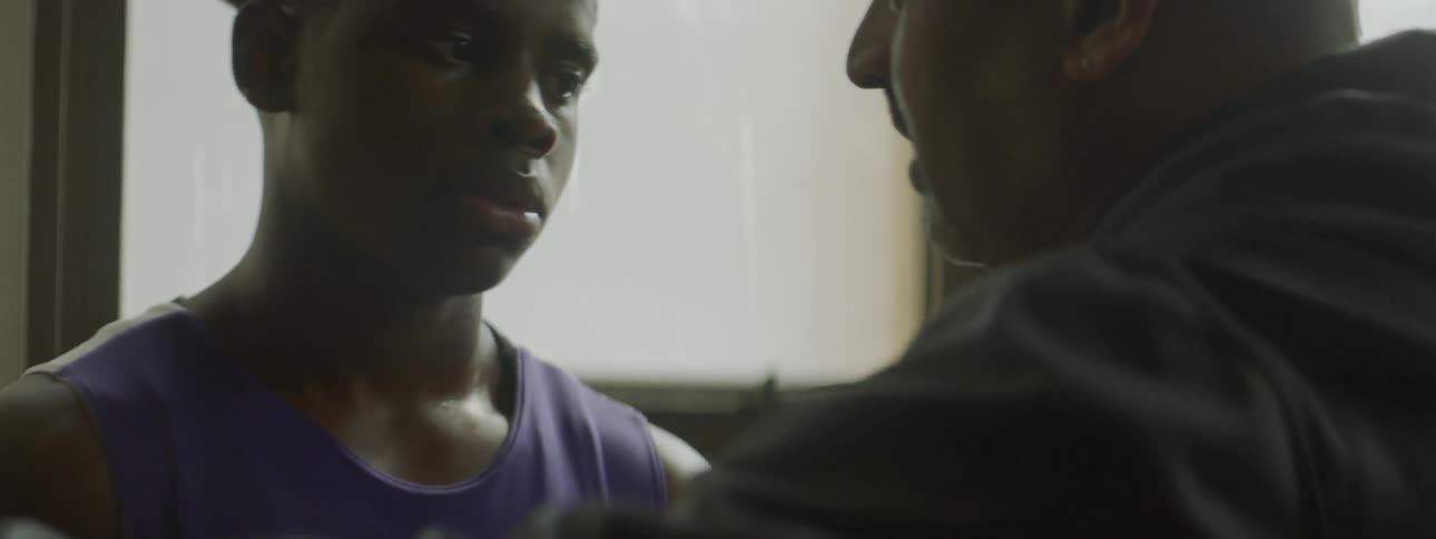 A man looks down wall talking to another man