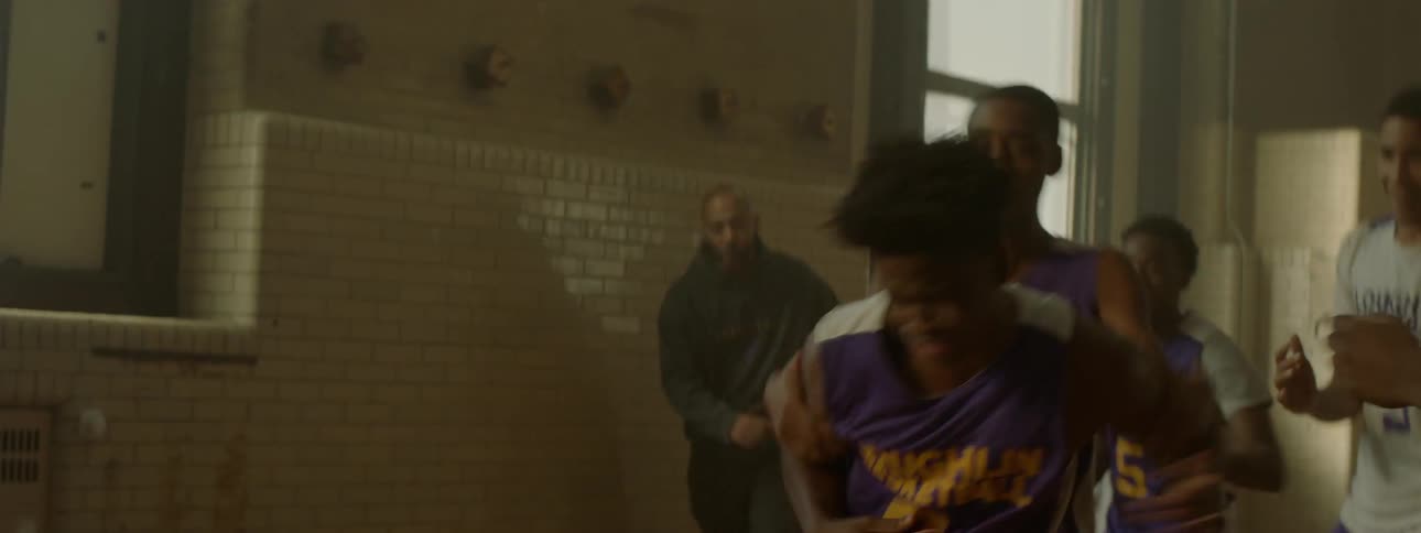 A group of boys fighting in a gym