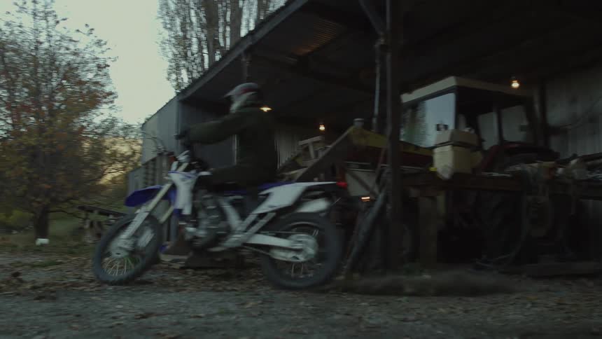 A motorcyclist takes off from his house