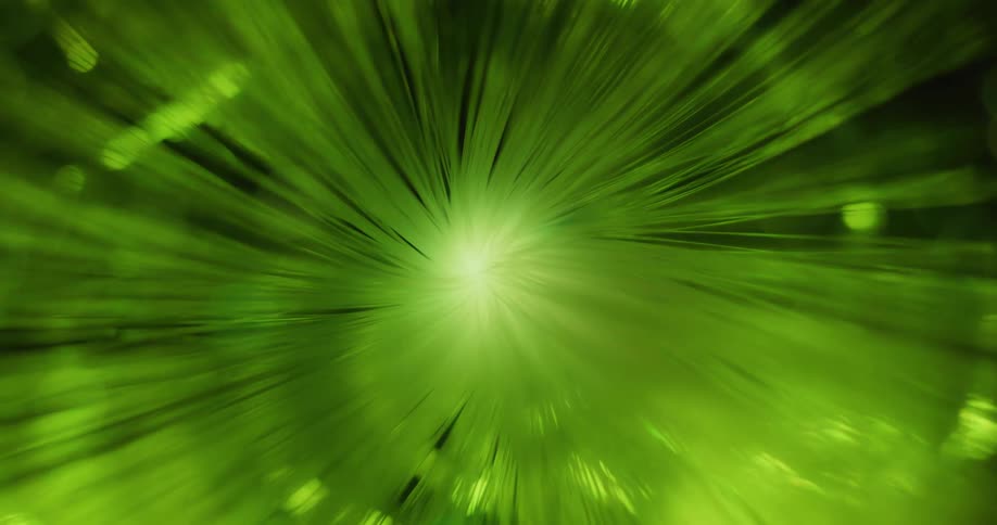 A flare emitting rays of changing colors turns and glows as orbs float and move in the darkness