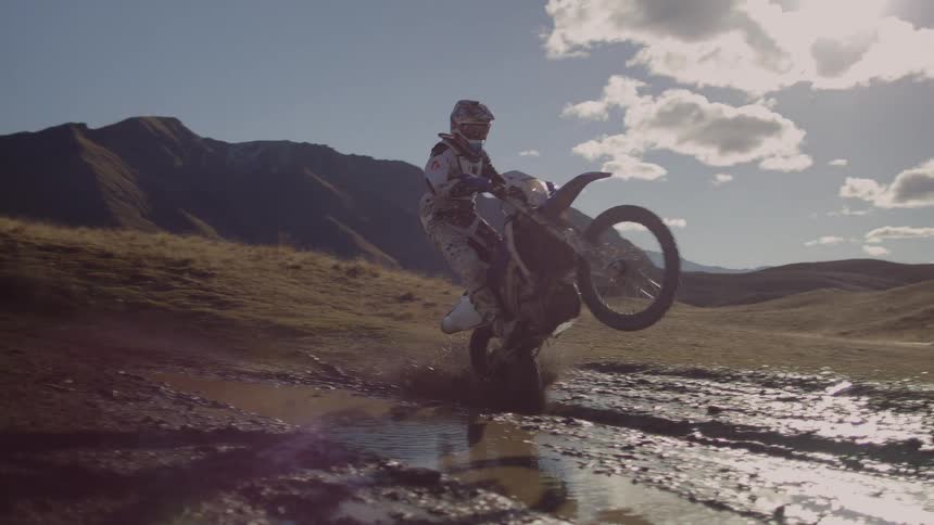A man is riding his motor bike in the nature area