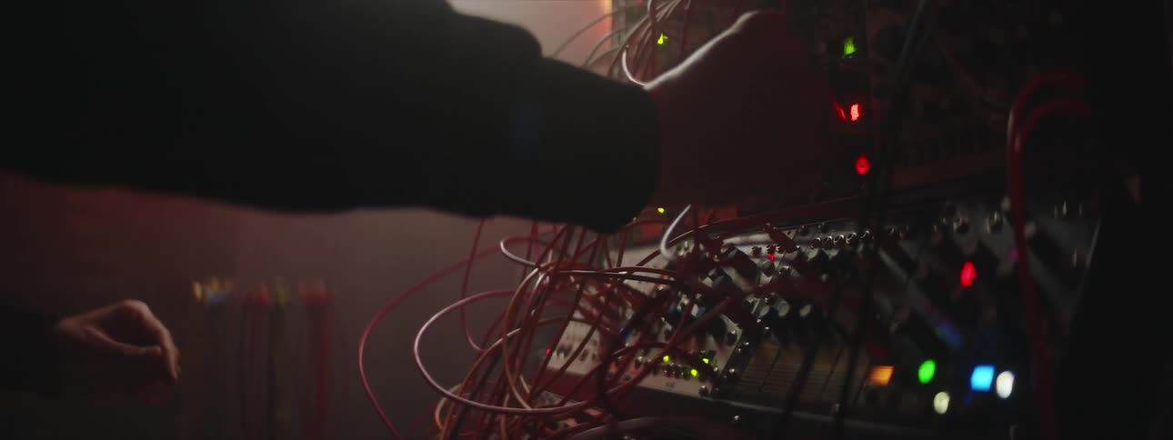 A man is playing music on a switchboard