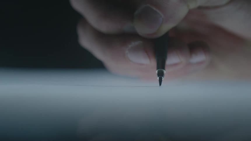 A man draws a line with a pen