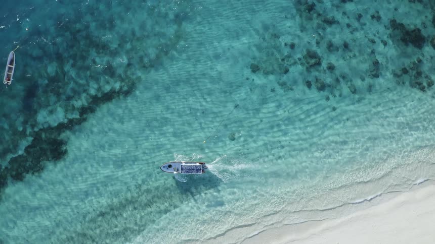 Boats are driving in the ocean water during midday