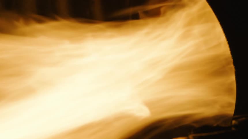 Large flames shoot out of a barrel