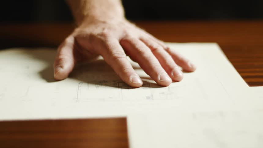 The view is of some ones hand and they are touching a table