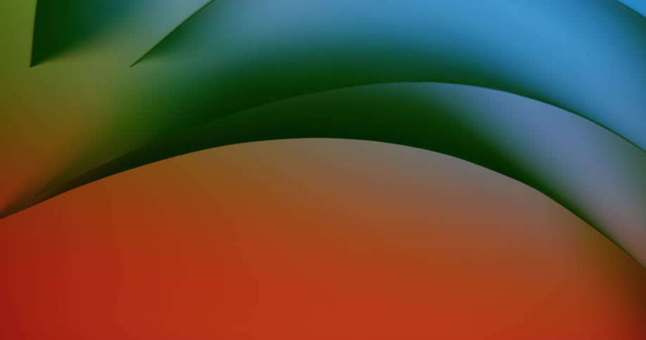 Colored lights shine on rounded shapes as they slowly move