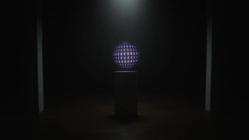 Close up of a screen displaying moving animated images inside a dimly lit room