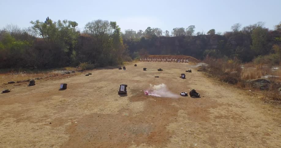 A red object explodes in a field