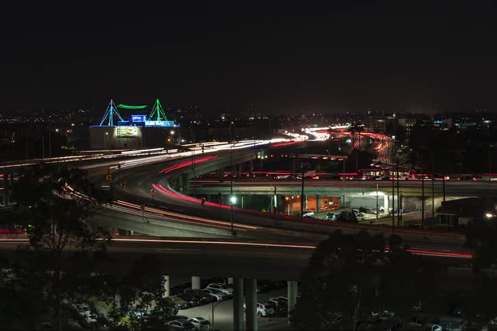 Time lapse of cars driving on highway at night in the city