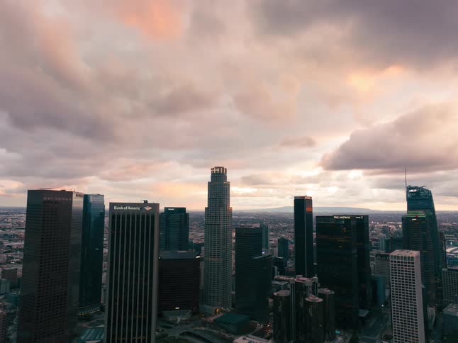 Clouds floating above tall skyscrapers in a city