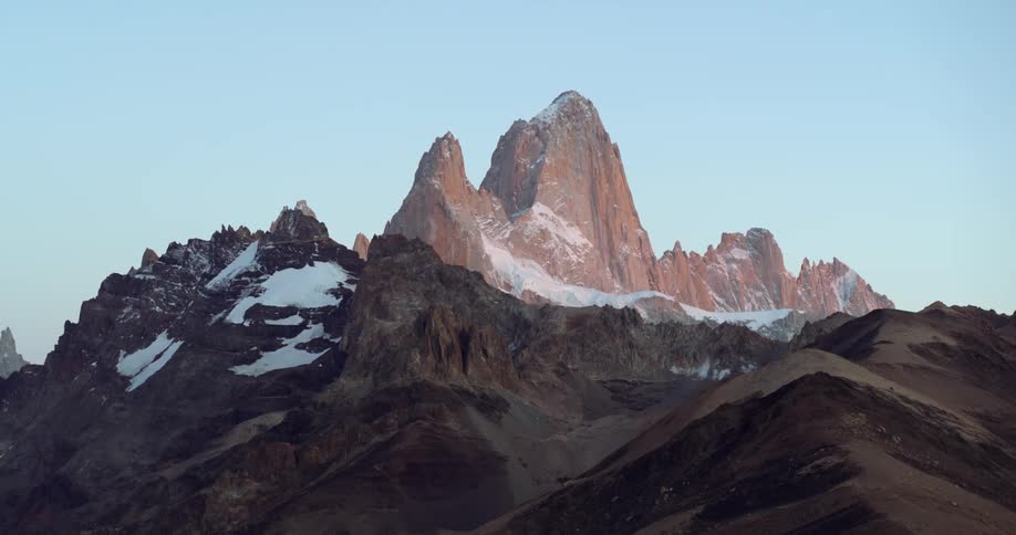 Snow settles in between peaks on a mountain