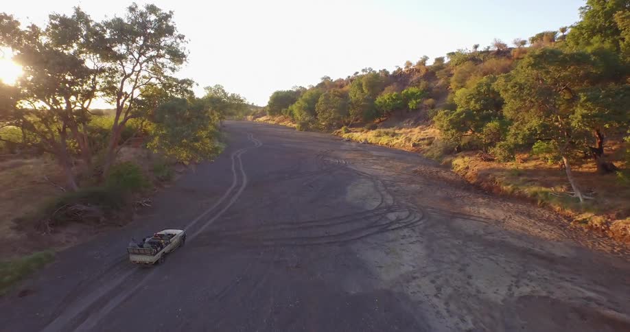 A car drives across a muddy road