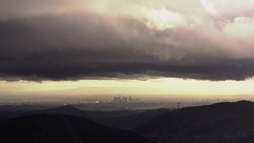 Time lapse view of a storm brewing above a city