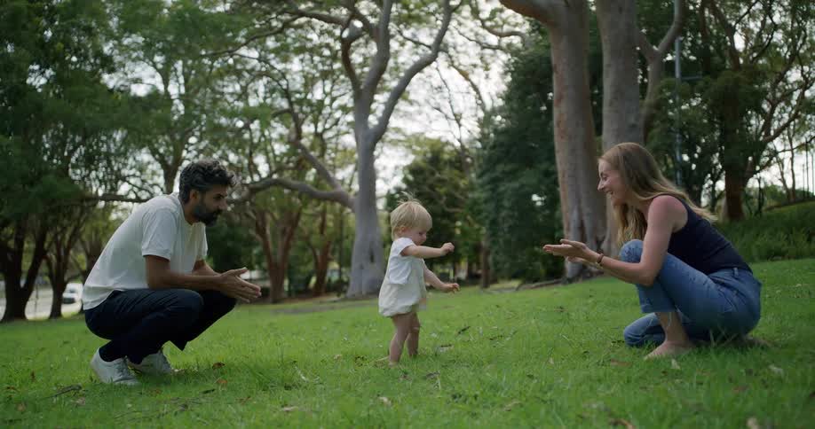 Parents watch their child walk