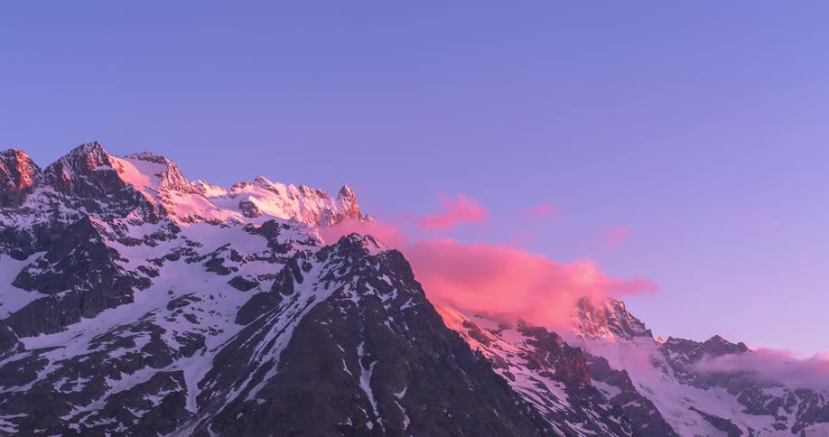 A time lapse of a sunset over a mountain